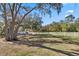 Spacious backyard features a white fence, mature trees, and ample room for recreation and relaxation at 3688 Hurlbut Cir, Lake Wales, FL 33898