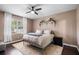 Comfortable bedroom with a ceiling fan, dark wood floors, and plenty of natural light at 3688 Hurlbut Cir, Lake Wales, FL 33898