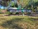 Welcoming entrance sign for Country Oaks, surrounded by lush greenery at 3688 Hurlbut Cir, Lake Wales, FL 33898