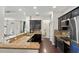 Modern kitchen with granite countertops, stainless steel appliances, and dark wood cabinets at 3688 Hurlbut Cir, Lake Wales, FL 33898