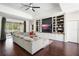 Cozy living room featuring custom built-ins, hardwood floors, and lots of natural light at 3688 Hurlbut Cir, Lake Wales, FL 33898