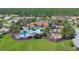 Aerial view of the community pool, clubhouse, and splashpad surrounded by palm trees and green spaces at 4002 Bougainvillea Pl, Kissimmee, FL 34746
