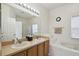 Bright bathroom features double sinks, a large mirror, soaking tub and separate shower at 4002 Bougainvillea Pl, Kissimmee, FL 34746