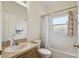 Bathroom with a neutral sink, toilet and tub with shower at 4002 Bougainvillea Pl, Kissimmee, FL 34746
