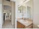 Bathroom featuring a sink with adjacent view of the kitchen and living room at 4002 Bougainvillea Pl, Kissimmee, FL 34746