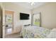 Relaxing bedroom featuring a ceiling fan and a large TV mounted on the wall at 4002 Bougainvillea Pl, Kissimmee, FL 34746