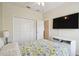 Bedroom features a ceiling fan and a large closet with doors at 4002 Bougainvillea Pl, Kissimmee, FL 34746