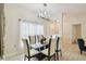 Bright dining room with tile floors, a modern chandelier, and a glass-top table at 4002 Bougainvillea Pl, Kissimmee, FL 34746