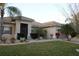 Beautiful home featuring a well-manicured lawn, tropical plants, and a tile roof at 4002 Bougainvillea Pl, Kissimmee, FL 34746