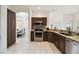 Well-lit kitchen boasts stainless steel appliances, wooden cabinetry, and access to the dining room at 4002 Bougainvillea Pl, Kissimmee, FL 34746