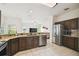 Kitchen features stainless steel appliances, granite countertop, and dark wood cabinets at 4002 Bougainvillea Pl, Kissimmee, FL 34746