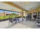 The screened lanai features a neutral floor, ceiling fans, and beautiful views of the manicured lawn and adjacent properties at 4002 Bougainvillea Pl, Kissimmee, FL 34746