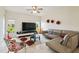 Spacious living room with tile floors, ample seating, and a large window overlooking the backyard at 4002 Bougainvillea Pl, Kissimmee, FL 34746