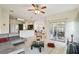 Open-concept living room with tile flooring, stylish furniture, and seamless access to the kitchen at 4002 Bougainvillea Pl, Kissimmee, FL 34746