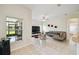 Airy living room features tile flooring, a modern sectional sofa, and views of the screened lanai at 4002 Bougainvillea Pl, Kissimmee, FL 34746