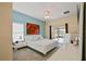 Airy primary bedroom with ceiling fan, large rose print, and access to the lanai at 4002 Bougainvillea Pl, Kissimmee, FL 34746