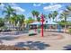 A colorful splashpad with playful water features provides a fun and refreshing experience for children in a tropical setting at 4002 Bougainvillea Pl, Kissimmee, FL 34746