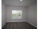 Cozy bedroom with neutral color palette, plush carpeting, and a bright window at 16906 Cedar Valley Cir, Clermont, FL 34711