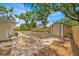 Large, fenced backyard with a storage shed, offering potential for outdoor activities at 2415 Sutton Rd, Lakeland, FL 33810