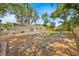 Spacious backyard featuring a sunny lawn and mature trees, providing ample privacy at 2415 Sutton Rd, Lakeland, FL 33810