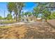 Single story home featuring a fenced yard, mature trees, and a shed at 2415 Sutton Rd, Lakeland, FL 33810