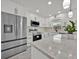 Modern kitchen with white cabinets, stainless steel appliances, and a marble countertop island at 2415 Sutton Rd, Lakeland, FL 33810