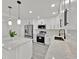 Bright kitchen featuring white cabinets, stainless steel appliances, and a quartz countertop island at 2415 Sutton Rd, Lakeland, FL 33810