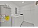 Bright laundry area features modern white appliances, shelving and an AO Smith 100 water heater at 2415 Sutton Rd, Lakeland, FL 33810