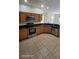 Well-lit kitchen featuring wood cabinets, stainless steel appliances, and granite countertops at 447 Wildflower Rd, Davenport, FL 33837