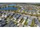 Aerial view of homes near a picturesque lake showcasing the community's serene setting and swimming pools at 9170 Tavistock Lakes Blvd, Orlando, FL 32827