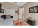 This bedroom features a daybed, floral rug, and two closets at 9170 Tavistock Lakes Blvd, Orlando, FL 32827