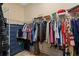 Organized walk-in closet with ample storage space and a blue dresser at 9170 Tavistock Lakes Blvd, Orlando, FL 32827