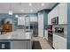 Well-lit kitchen features modern appliances, white cabinets, and a center island at 9170 Tavistock Lakes Blvd, Orlando, FL 32827