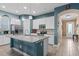 Well-lit kitchen features modern appliances, white cabinets, and a center island at 9170 Tavistock Lakes Blvd, Orlando, FL 32827