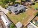 Aerial view of a home with a large backyard, detached garage, and gray roof at 1508 Leighton Ave, Lakeland, FL 33803