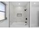 Bright bathroom featuring a marble-tiled shower with a built-in shelf at 1508 Leighton Ave, Lakeland, FL 33803