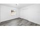 Clean bedroom featuring luxury vinyl flooring, a closet, and a bright window at 1508 Leighton Ave, Lakeland, FL 33803