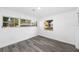 This bedroom has hardwood floors, three windows, and white walls at 1508 Leighton Ave, Lakeland, FL 33803