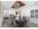 Elegant dining room with modern light fixture, dark wood table, and luxury vinyl floors at 1508 Leighton Ave, Lakeland, FL 33803