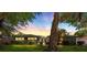 Charming single-story home with manicured lawn and mature trees at sunset at 1508 Leighton Ave, Lakeland, FL 33803
