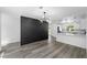 Modern living space open to bright kitchen with breakfast bar and luxury vinyl floors at 1508 Leighton Ave, Lakeland, FL 33803