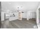 Open-concept living space with modern kitchen, stylish lighting, and luxury vinyl floors at 1508 Leighton Ave, Lakeland, FL 33803