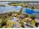 Scenic aerial view of lakeside homes with lush landscaping and beautiful water views from multiple residences at 252 Bayou Bend Rd, Groveland, FL 34736