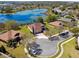 Aerial view of a beautiful home with lake view, lush greenery, and a well-manicured lawn at 252 Bayou Bend Rd, Groveland, FL 34736