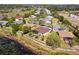 Aerial view of homes situated near a serene lake, featuring screened patios, lush landscaping, and a tranquil setting at 252 Bayou Bend Rd, Groveland, FL 34736