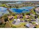 Aerial view of lakeside homes shows beautiful water views and lush landscaping in a desirable community at 252 Bayou Bend Rd, Groveland, FL 34736