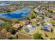 Aerial view of lakeside homes features well-manicured lawns and stunning water views from multiple properties at 252 Bayou Bend Rd, Groveland, FL 34736