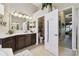 Well-lit bathroom boasts a double vanity, decorative mirrors, and convenient access to the bedroom at 252 Bayou Bend Rd, Groveland, FL 34736