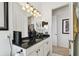 Bathroom featuring granite countertop with modern fixtures, white cabinetry and well-lit vanity at 252 Bayou Bend Rd, Groveland, FL 34736