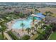 Aerial view of a large community pool surrounded by palm trees and lounge chairs on a sunny day at 252 Bayou Bend Rd, Groveland, FL 34736